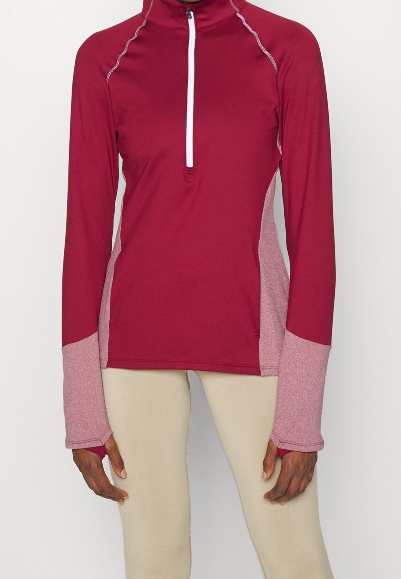 Långärmad träningströja i bordeaux med grå detaljer, med en kvart-slips-halsringning, mjukt tyg och platta sömmar för komfort.