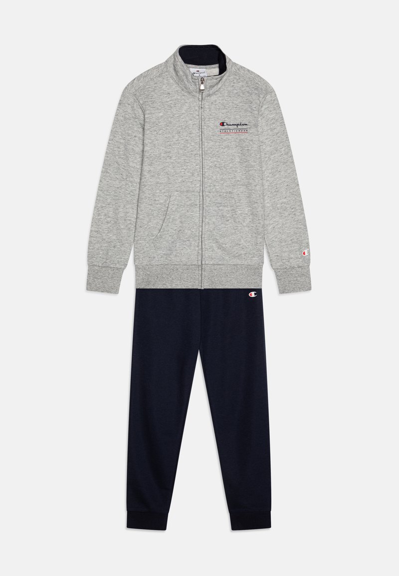 Gray zip-up sweatshirt with side pockets and ribbed cuffs, paired with navy sweatpants featuring a logo on the waistband. Cotton material.