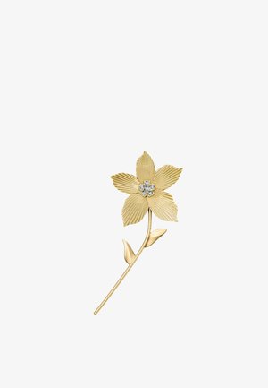 Broche fleur en or avec des pétales texturés, deux feuilles sur la tige et un groupe de petites pierres précieuses claires au centre.