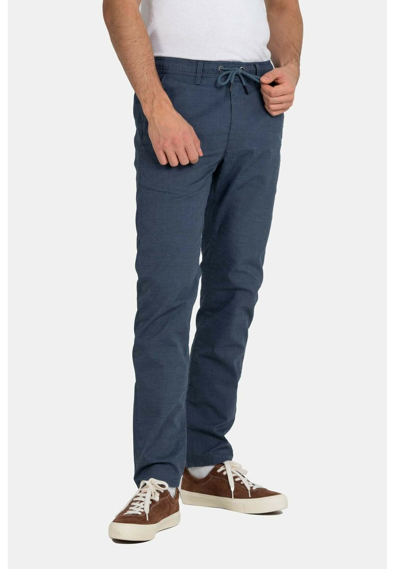 Navy blue tapered pants made of lightweight fabric, featuring an elastic waistband with a drawstring and side pockets.