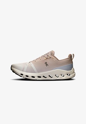 Lightweight athletic shoe in shades of beige and gray, featuring a mesh upper, cushioned sole, and distinctive cut-out design in the sole.