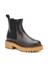 Botín de piel negra hasta el tobillo con paneles laterales elásticos, suela gruesa beige y detalle de costura en contraste a lo largo de la suela.