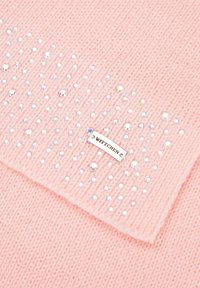 Tissu tricoté rose agrémenté de perles transparentes et iridescentes dispersées. Une étiquette métallique marquée "WITTCHEN" est attachée.