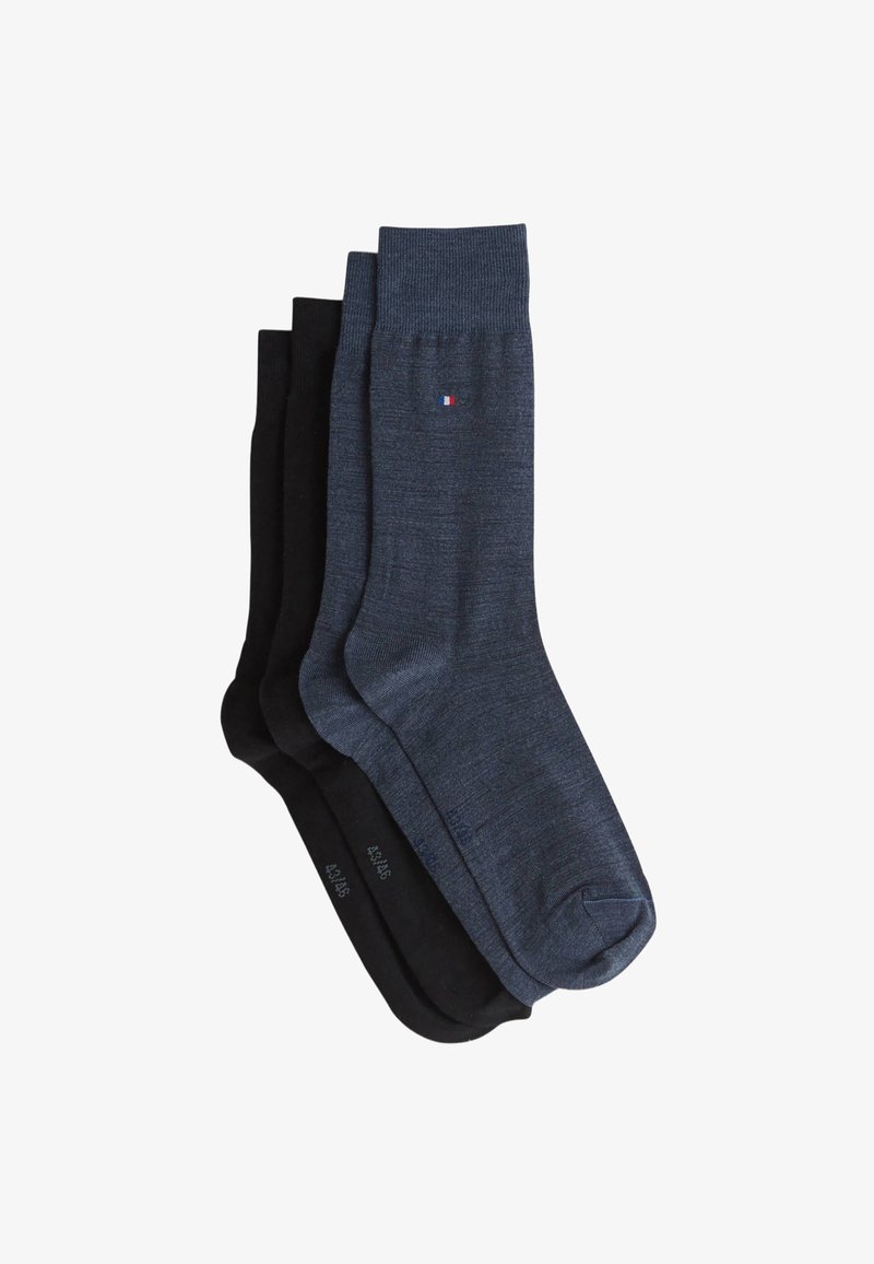 Trois paires de chaussettes : une bleu foncé avec un revers côtelé, une noire unie, et une autre noire avec une texture lisse. Chaque paire présente un logo discret.