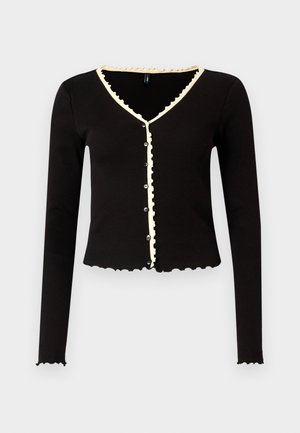 Zwarte geribde cardigan met lange mouwen, gegolfde randen en een crème kleurige bies langs de halslijn en de knopenlijst. Voorzien van knopen aan de voorkant.