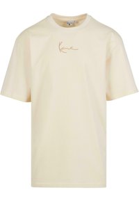 Cream-colored cotton t-shirt with short sleeves and a crew neckline; features a contrasting beige signature logo on the front.