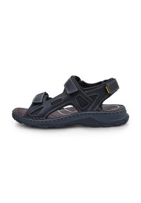 Mustad mustad sandaalid mitme Velcro rihmaga, avatud külgedega, tekstuuriga sisetald ja tugev kummist välistald. Nähtav õmblus lisab detaili.