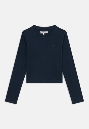 Granatowy, długi rękaw, krótki prążkowany top z okrągłym dekoltem i małym logo Tommy Hilfiger na lewej piersi.