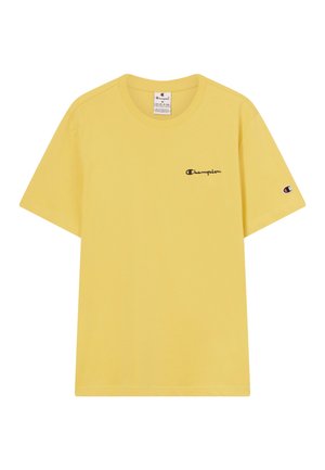 Camiseta de Champion amarilla de manga corta con pequeño texto de logo negro en el pecho y logo bordado en la manga izquierda.