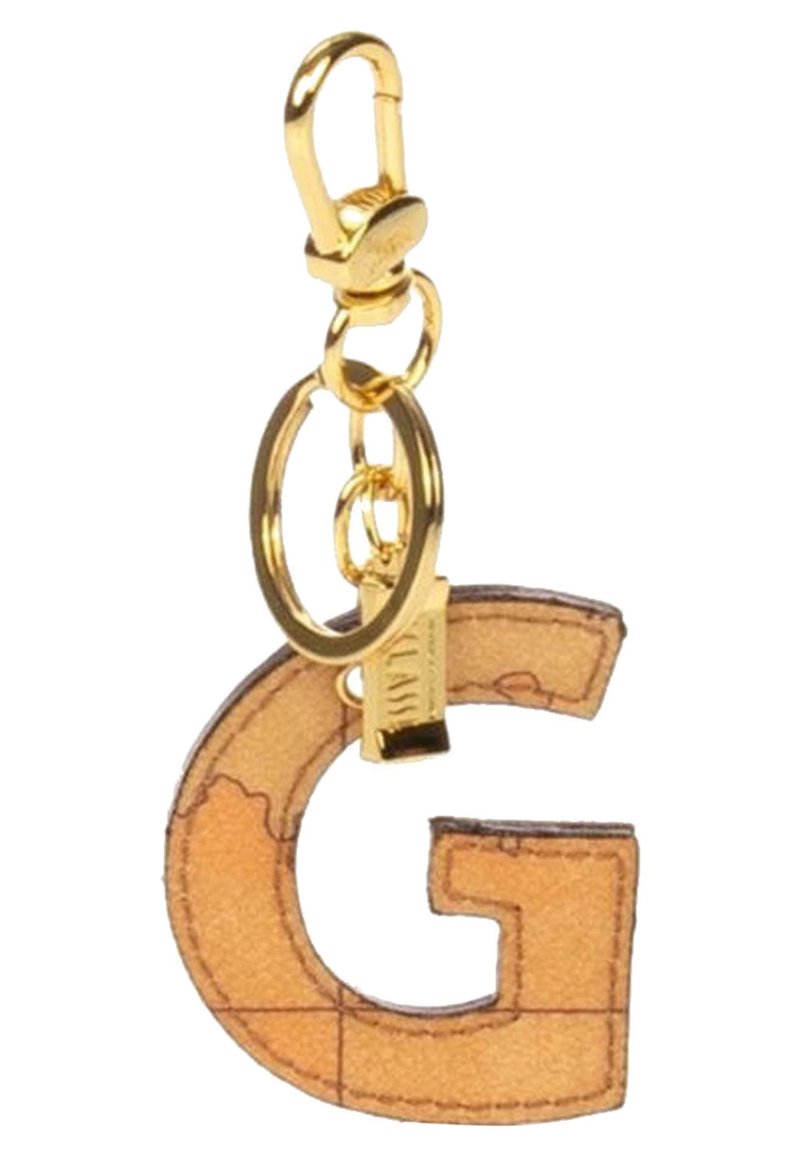 Porte-clés en ton doré présentant la lettre "G" dans un motif de carte beige, complété par un anneau circulaire et un matériel de fermoir.