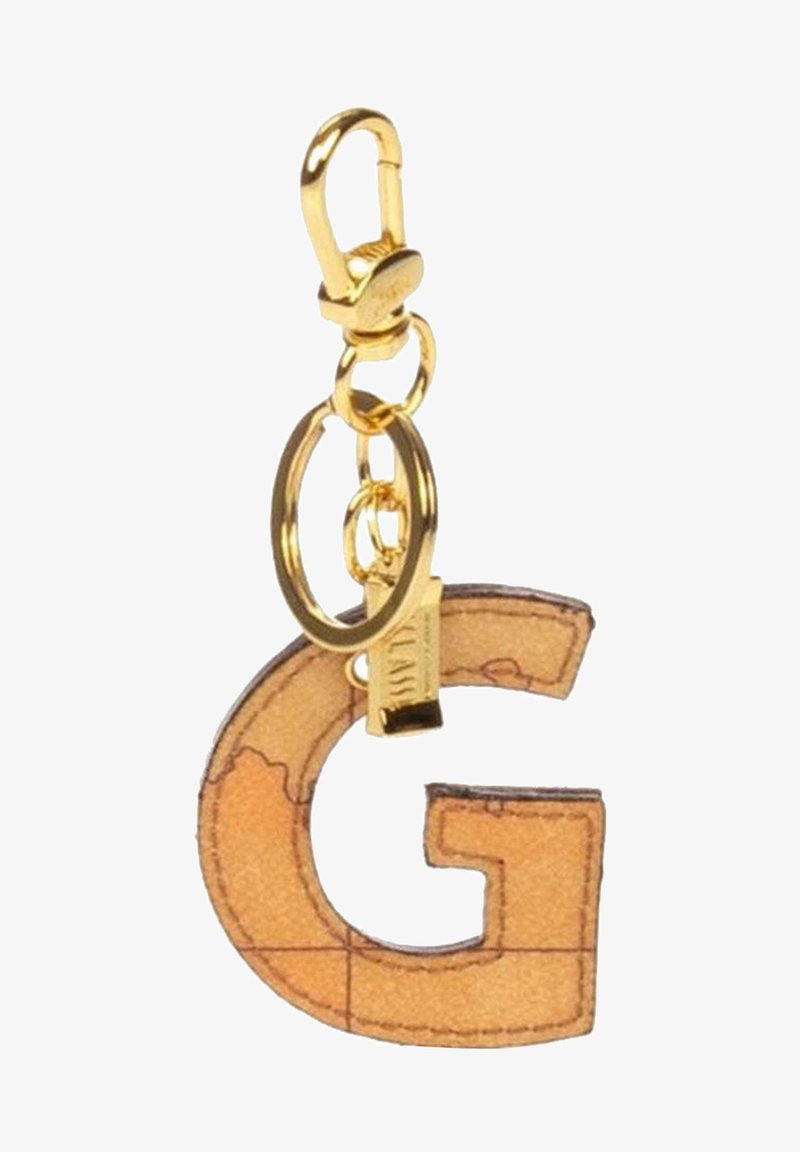 Porte-clés en ton doré présentant la lettre "G" dans un motif de carte beige, complété par un anneau circulaire et un matériel de fermoir.
