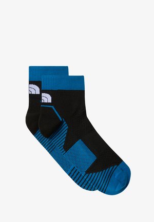 Czarne i niebieskie skarpetki do kostek o teksturowanym wzorze. Posiadają niebieską ściągaczkę i graficzne wzory w różnych odcieniach niebieskiego i czarnego.