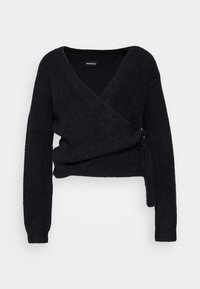 Pull cache-cœur noir à manches longues avec encolure en V et détail noué sur le côté, en tissu tricoté doux et texturé.