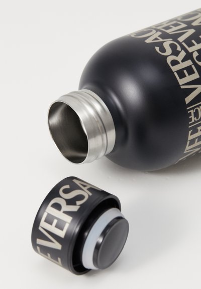 Stainless steel water bottle in matte black with gold text. Screw cap with rubber seal, designed for durability and insulation.