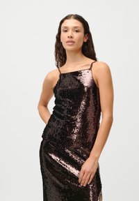 Black and bronze sequin dress with thin shoulder straps and a form-fitting silhouette, featuring a side slit and smooth texture.