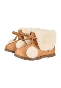 Braune Wildlederschuhe mit einem flauschigen cremefarbenen Bund, verziert mit weißen Pompons und braunen Bandakzenten an der Vorderseite. Flachsohlendesign.