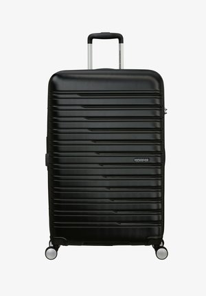 Schwarzer Hartschalenkoffer mit gerippter Oberfläche, teleskopischem Griff, zwei Rädern und Logodetail. Glatte Oberfläche, strapazierfähiges Material.