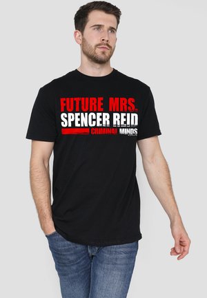 Black t-shirt featuring bold white and red text reading "FUTURE MRS. SPENCER REID CRIMINAL MINDS." Short sleeves and standard fit.