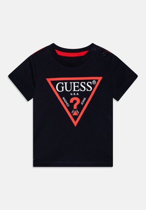 Navy blue cotton t-shirt with red accents and short sleeves. Features a large red triangle logo with white text "GUESS U.S.A." and graphic.