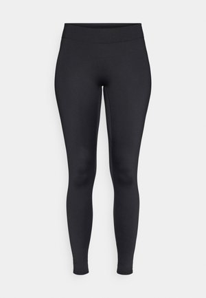 Melni legingi, kas izgatavoti no elastīga, gluda auduma ar augstu vidukli. Ievērojama forma un potītes garuma griezums.