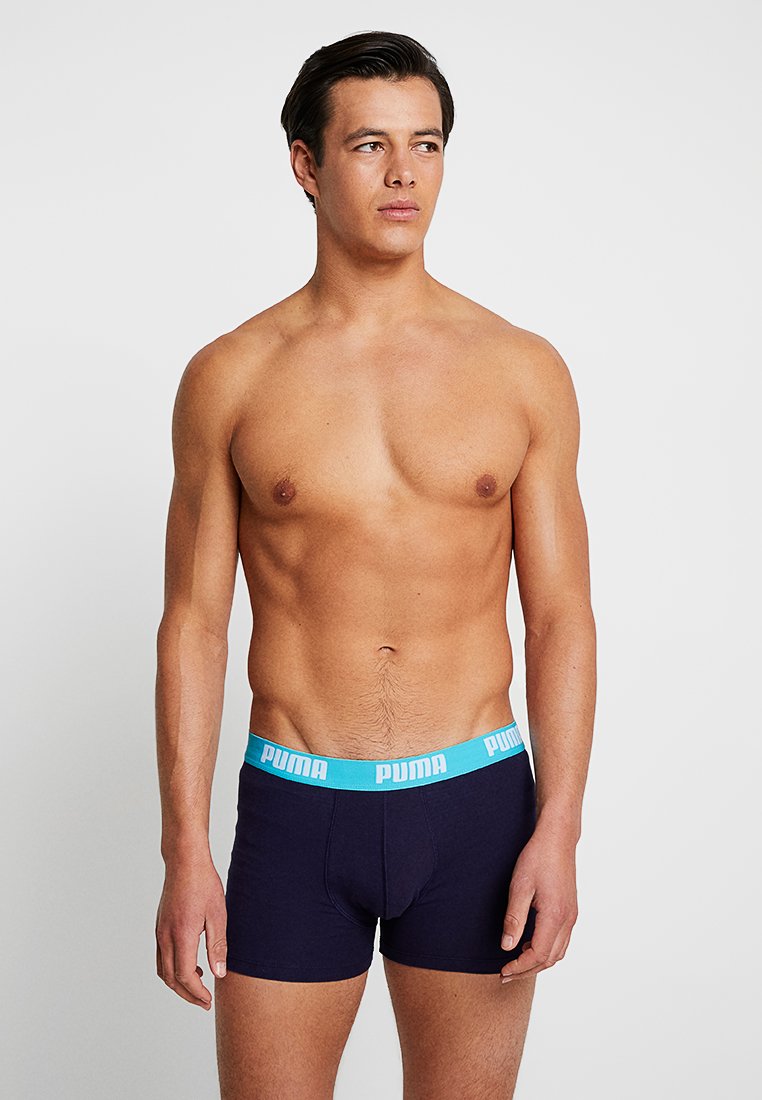 Navy blue boxer shorts with a light blue waistband featuring the "PUMA" logo. Made of soft, stretch fabric for comfort and fit.