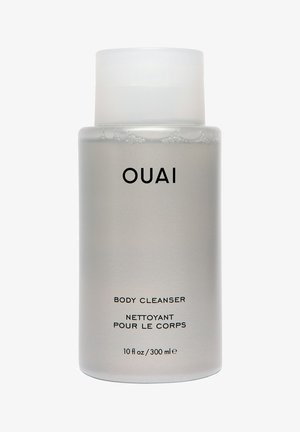 Przezroczysta butelka ze matowego szkła z białą zakrętką, oznaczona napisem "OUAI BODY CLEANSER", 10 fl oz/300 ml, o eleganckim designie.