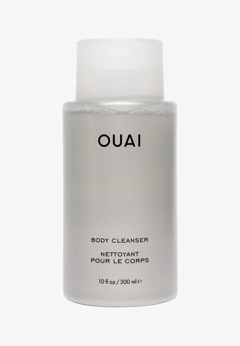 Transparent frostad flaska med ett vitt lock, märkt "OUAI BODY CLEANSER," 10 fl oz/300 ml, med en elegant design.