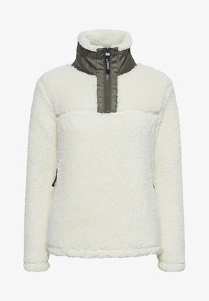 Pull en polaire crème avec un col haut, un devant zippé et un panneau en olive contrastant. Comprend un tissu texturé et doux ainsi que des poches latérales.