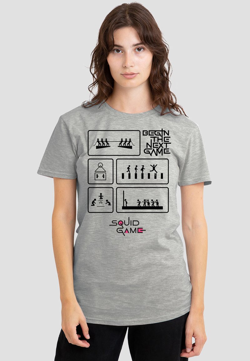 Gray cotton t-shirt featuring black graphic illustrations and text "BEGIN THE NEXT GAME" and "SQUID GAME" in pink, short sleeves, relaxed fit.