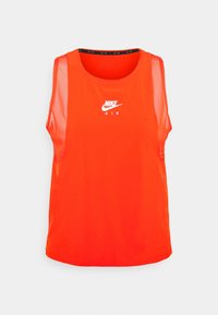 Pomarańczowy bezrękawnik Nike Air wykonany z oddychającego materiału, z okrągłym dekoltem i białym logo umieszczonym na środku klatki piersiowej.