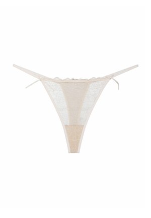 Lace thong in nude and white, featuring floral patterns, scalloped edges, and thin side ties. Semi-sheer texture throughout.