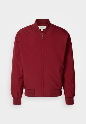 Burgundy bomber jacket made of smooth fabric, featuring a stand collar, ribbed cuffs and hem, and two side zip pockets.