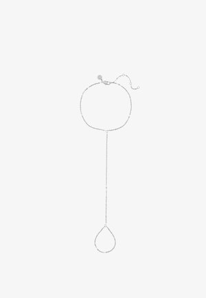 Delicate silver chain hand harness with adjustable clasp, connecting a wrist bracelet to a teardrop-shaped finger loop.
