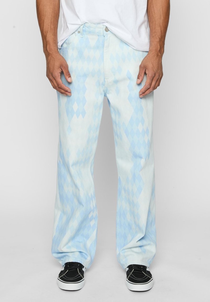 Light blue denim jeans with a diamond pattern, straight-leg design, five-pocket style, and silver button closure. Paired with black sneakers.