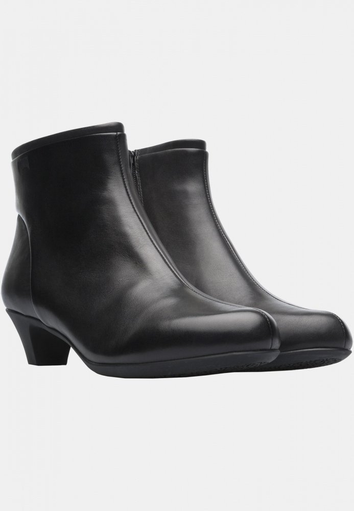 Stivali alla caviglia in pelle nera con tacco basso, superficie liscia, punta arrotondata e cerniera laterale. Design semplice con accenti minimi.