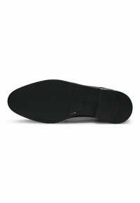 Sola di scarpa in pelle nera, texture liscia, forma arrotondata, minimalista nel disegno della suola, dettaglio del logo impresso, cucitura a contrasto lungo il bordo.