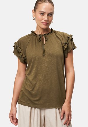 Olive green short-sleeve top with ruffled accents, keyhole neckline with tie detail, made from soft, textured fabric. Simple and relaxed fit.