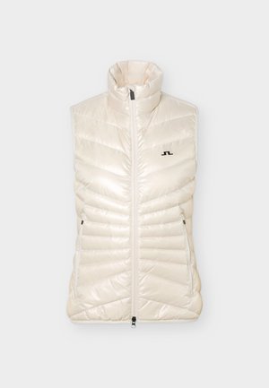 Vestă matlasată fără mâneci, de culoare crem, cu guler înalt, fermoar frontal, două buzunare cu fermoar și un mic logo negru pe piept.