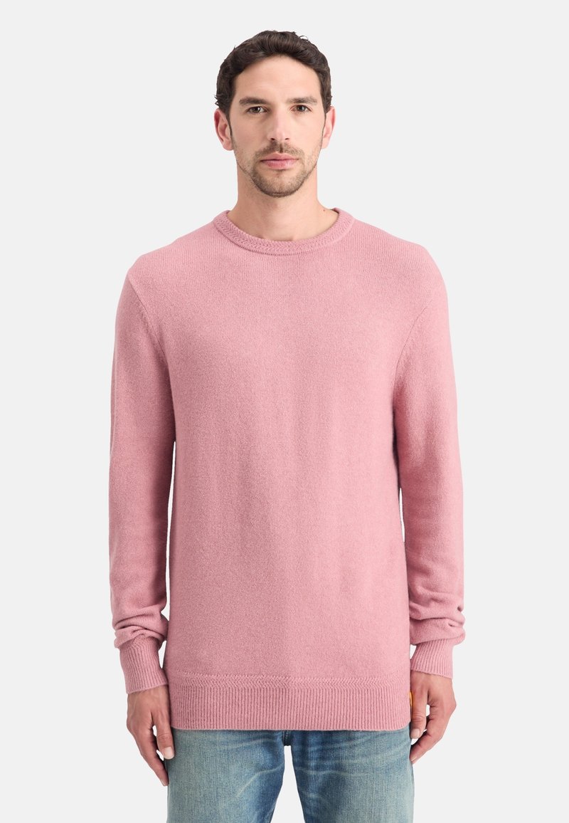 Suéter de punto rosa con cuello redondo, mangas largas y puños y dobladillo acanalados. El material tiene una textura suave y un diseño ajustado.