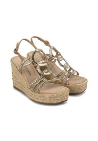 Sandali con zeppa con suola in juta intrecciata, cinturini beige e dettagli metallici circolari. Caratterizzati da un design slingback e una soletta imbottita.