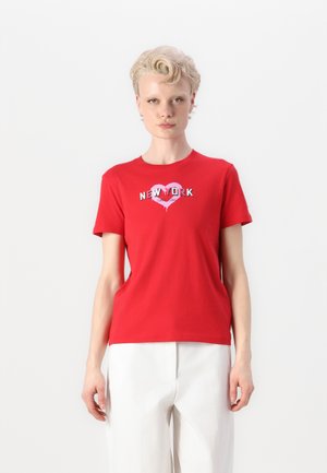 Red cotton t-shirt with short sleeves, featuring a graphic "NEW YORK" text in a heart design, displayed on a plain background.