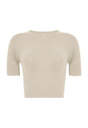 Pull court beige à manches courtes avec un col rond et un petit détail vertical à pois sous le col.