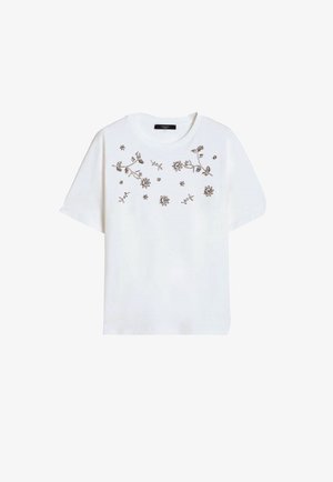 Top bianco a maniche corte con scollo tondo e ricamo floreale marrone sparso sul petto e sulla parte anteriore superiore.