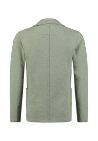 Chaqueta de manga larga verde claro con una costura en la parte posterior, bolsillos laterales y un pequeño cuello, vista desde la parte de atrás.