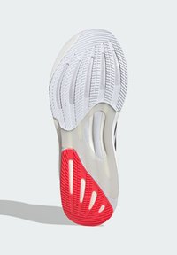 Semelle de chaussure avec une base en caoutchouc blanc, surface texturée, accents rouges et rainures à motifs pour l'adhérence. Comprend des sections de rembourrage transparent.