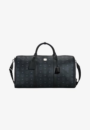Black textured leather duffel bag with logo pattern, dual handles, detachable shoulder strap, and a small attached tags.