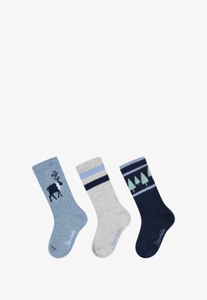 Three pairs of crew socks: one with a deer graphic on blue, one gray with blue stripes, and one dark blue with green trees. Knit texture.
