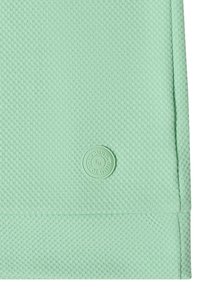 Tissu texturé vert clair avec un petit logo rond embossé comportant les lettres "Ba" et la phrase "MIND TO YOUR MIND"