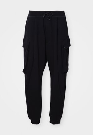 Black jogger pants made from soft fabric, featuring an elastic waistband with a drawstring, side cargo pockets, and ribbed ankle cuffs.