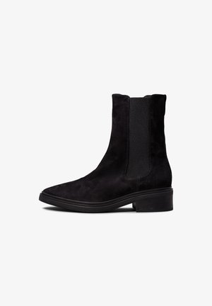 Must have musta kootjalinnud, millel on elastsed külgpaneelid, terav nina ja virnastatud konts. Omab õmblusteenuseid ja sujuvat kummist talla.